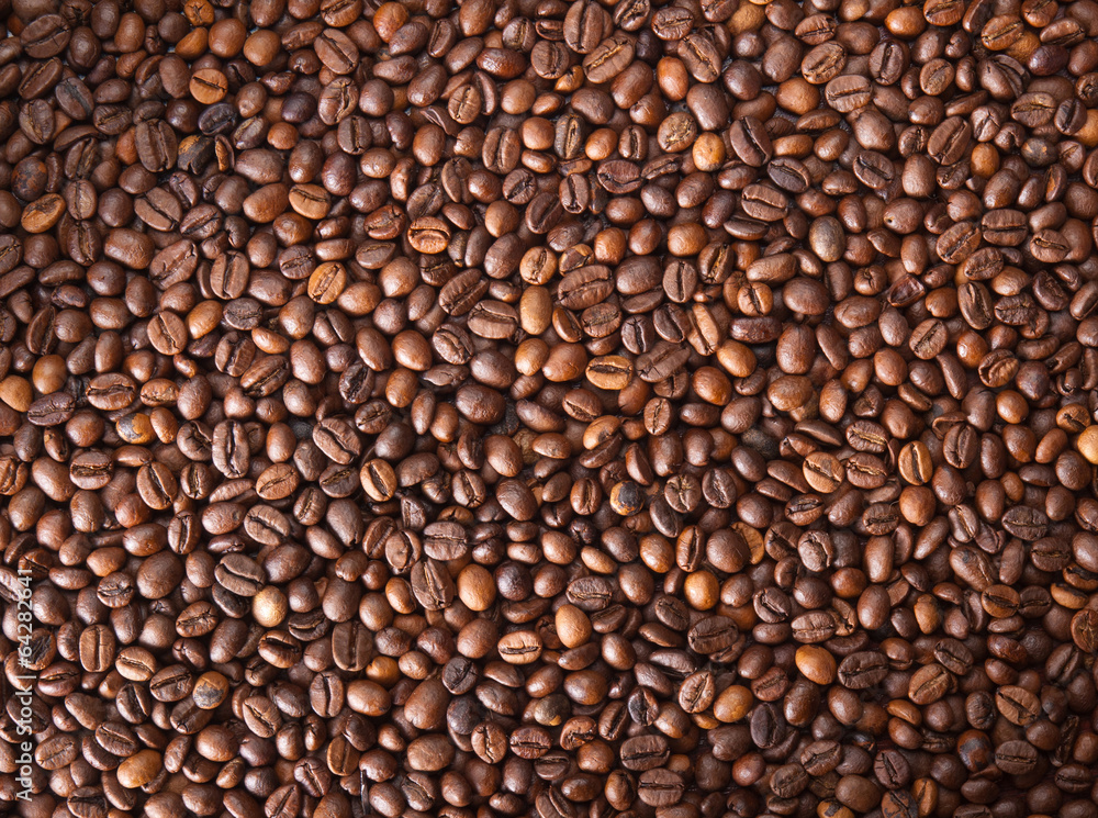 Numerous coffee beans which have been scattered all over the sur Numerous coffee beans which have been scattered all over the sur