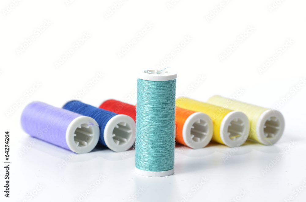 Colorful sewing threads isolated on white background Colorful sewing threads isolated on white background