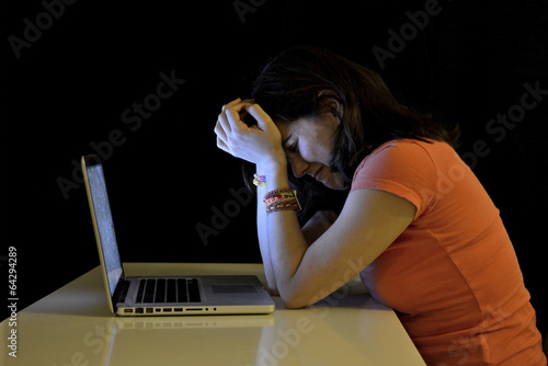 Young student woman and computer crying desperate suffering