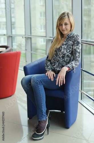 Young beautiful woman sitting on a chair