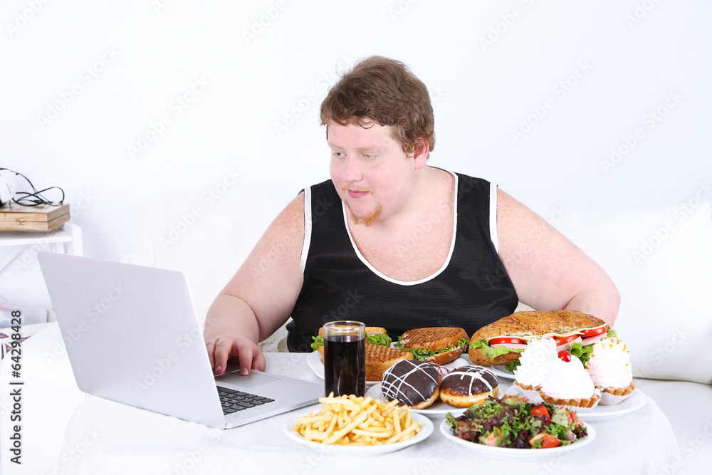 Fat man has a big lunch and playing games