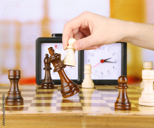 Woman playing chess, close up