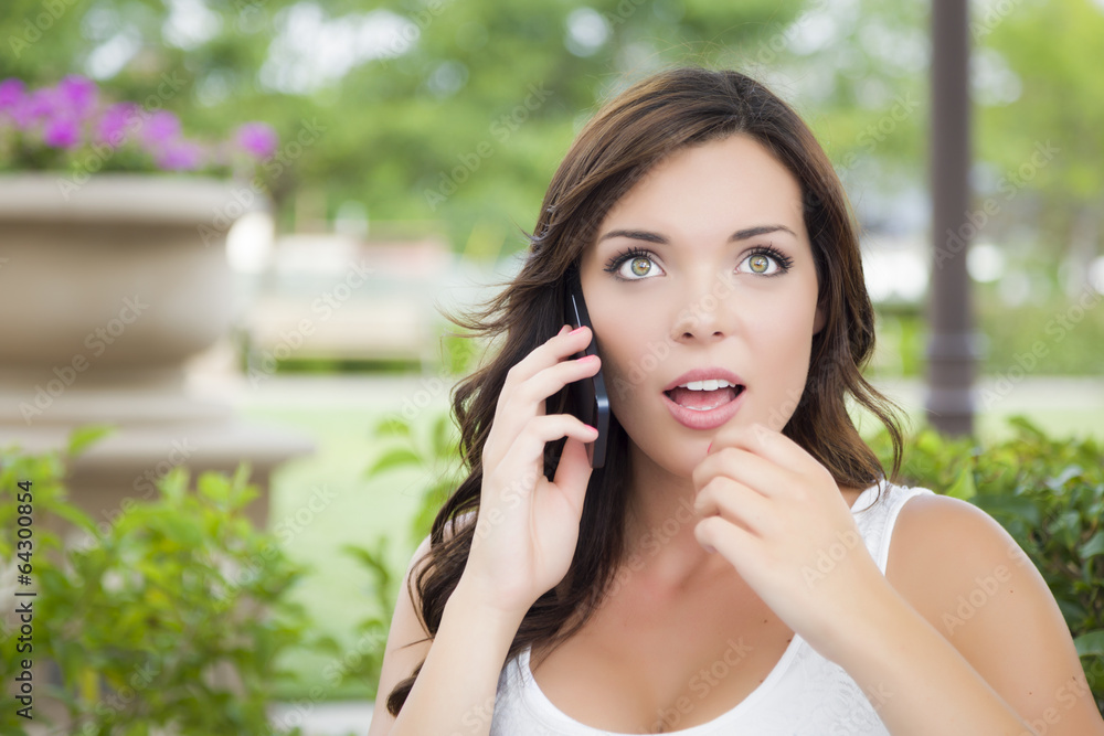 Stunned Young Adult Female Talking on Cell Phone Outdoors Stunned Young Adult Female Talking on Cell Phone Outdoors