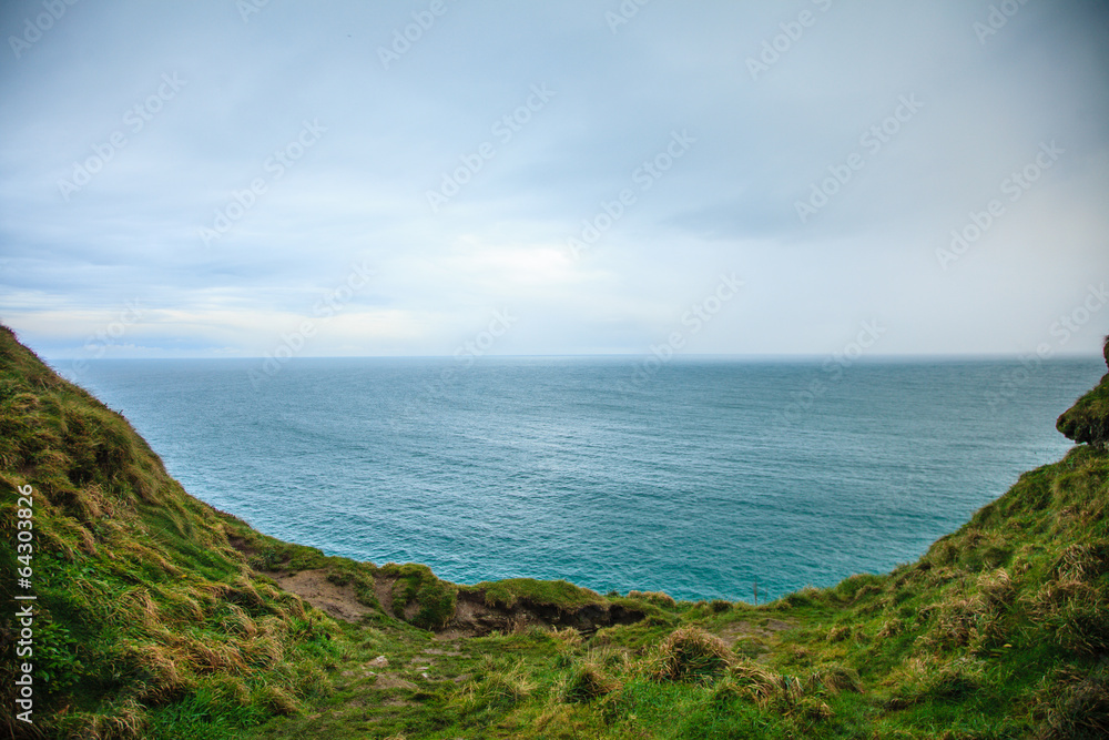  Alantic ocean and field of green grass, Ireland Europe