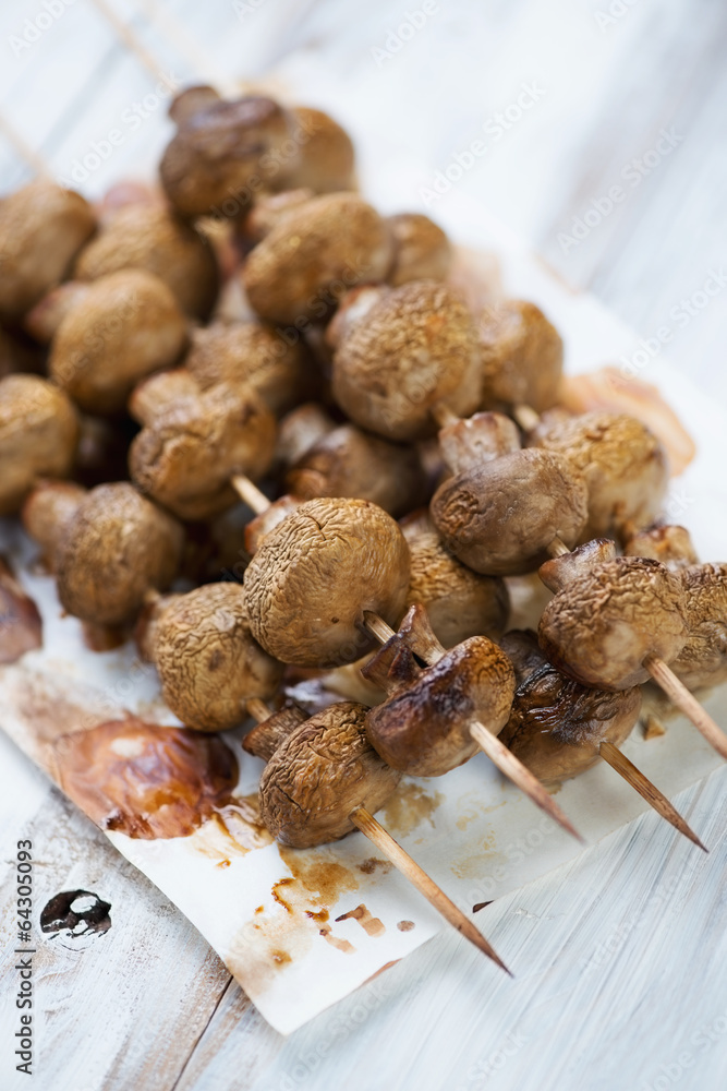 Baked champignon kebabs, vertical shot, close-up Baked champignon kebabs, vertical shot, close-up