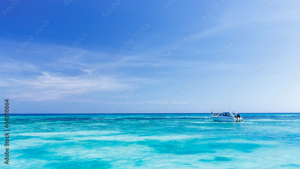A tourist speed boat in crystal clear blue sea at tropical islan