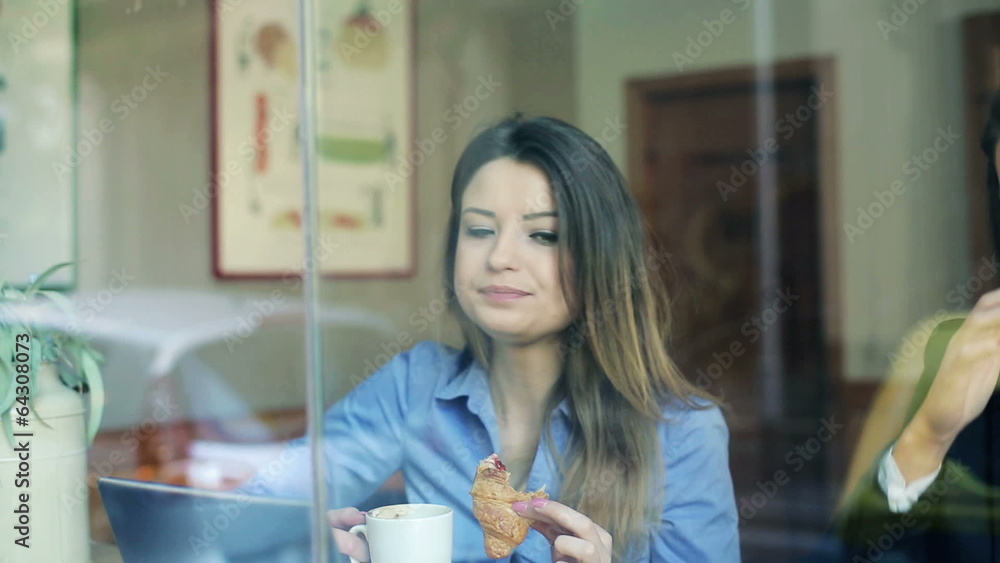 Young businesswomen chatting over coffee during coffee break Young businesswomen chatting over coffee during coffee break