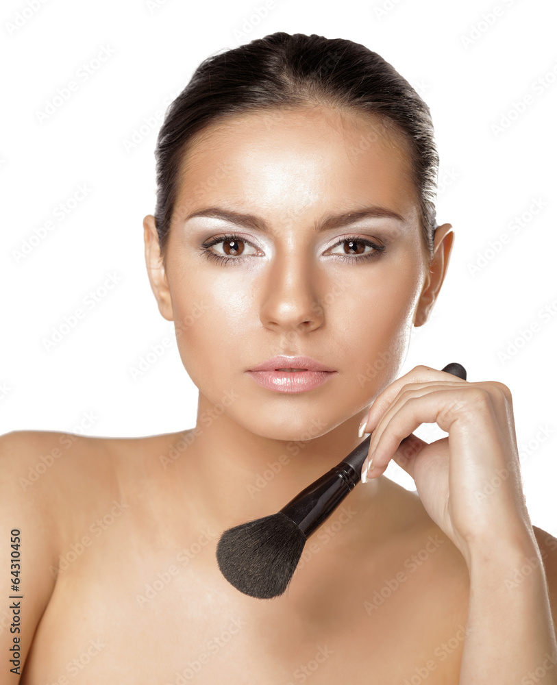 Portrait of attractive young adult woman applying blusher Portrait of attractive young adult woman applying blusher