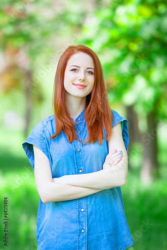 Redhead girl in the park in spring time.