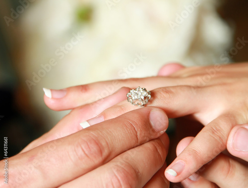 man putting wedding ring on woman hand. © lenets_tan