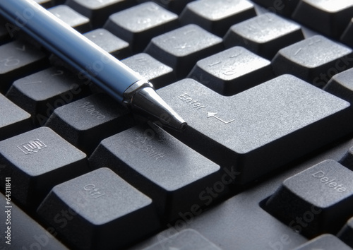 pen on computer keyboard. © lenets_tan
