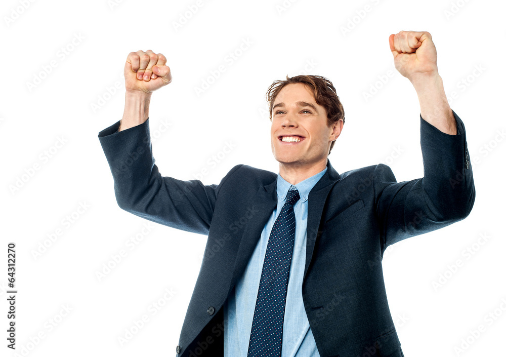Businessman celebrating success with arms up