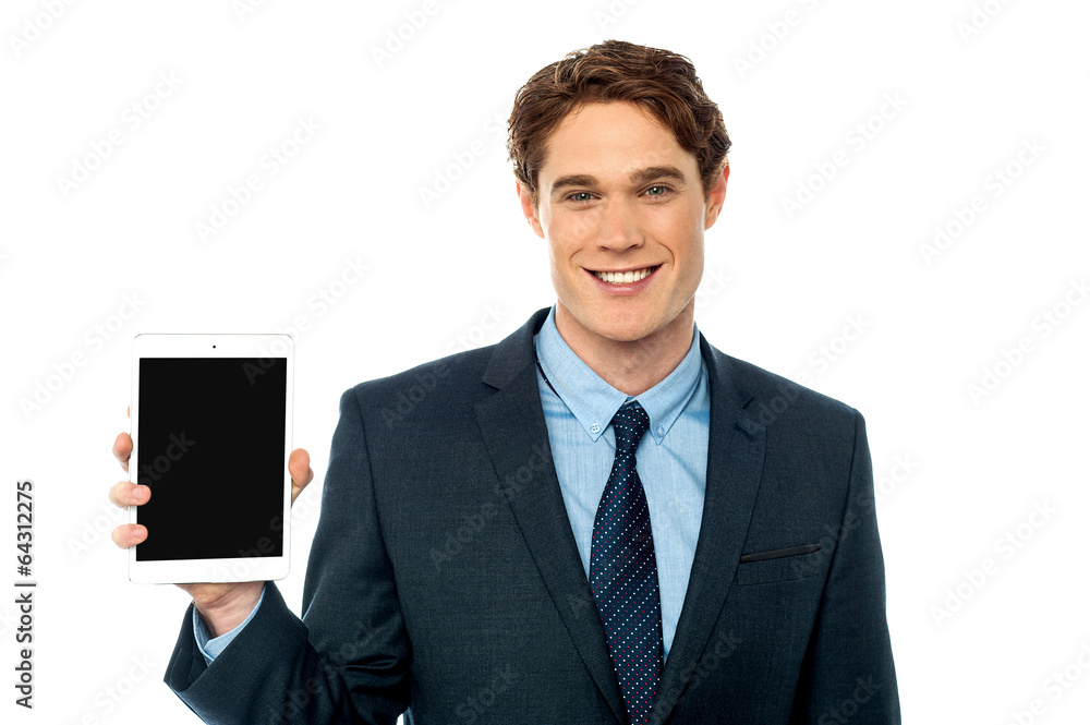 Young man showing newly launched tablet device Young man showing newly launched tablet device