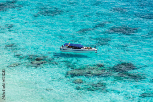 Aerial view of the tropical island, clear blue sea and a boat at © aiaikawa