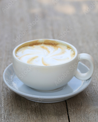 Cappuccino coffee cup on wooden background