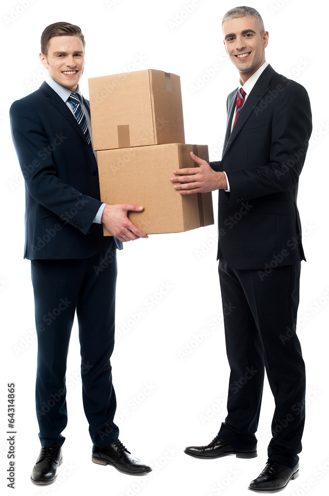 Male executives posing with cardboard boxes Male executives posing with cardboard boxes