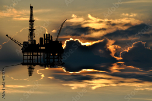 Illustration of oil platform on sea and sunset in background