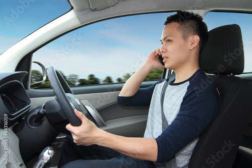 A man driving while talking on a cellphone