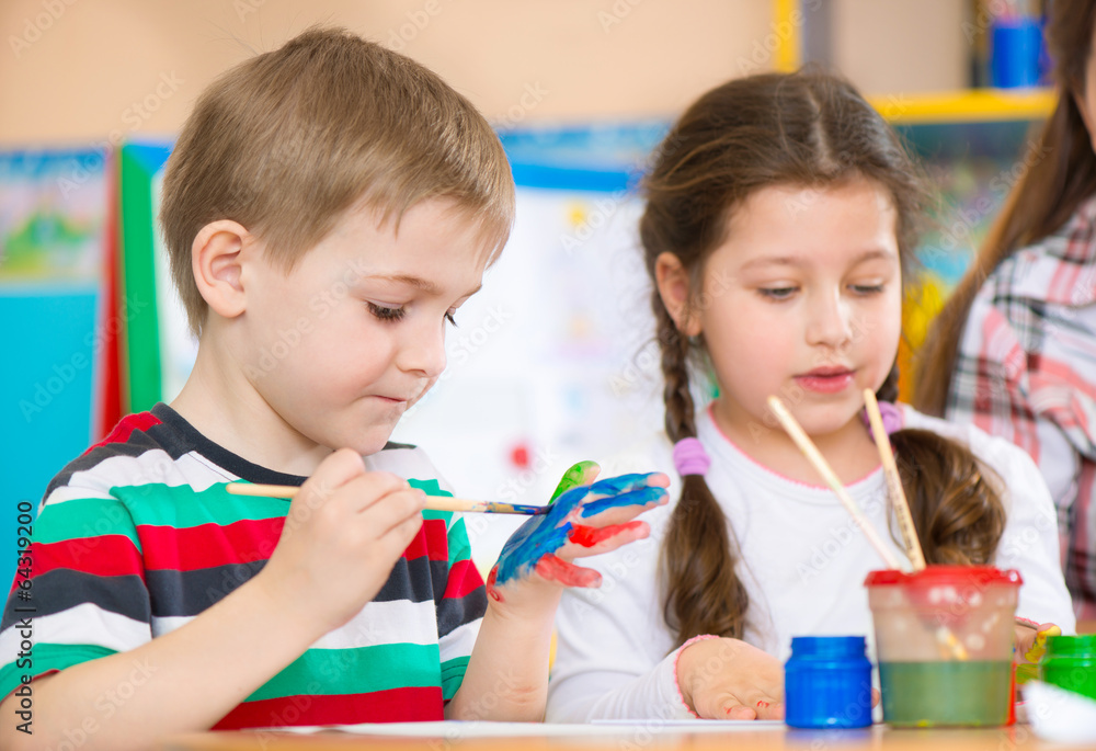 Cute children painting at kindergarten Cute children painting at kindergarten