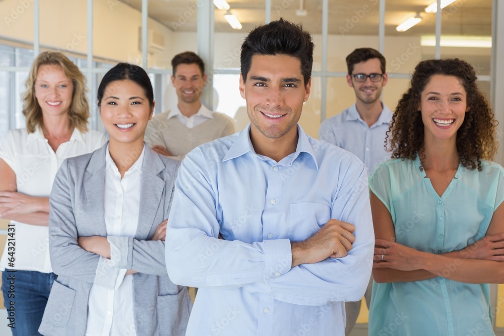 Casual business team smiling at camera with arms crossed Casual business team smiling at camera with arms crossed