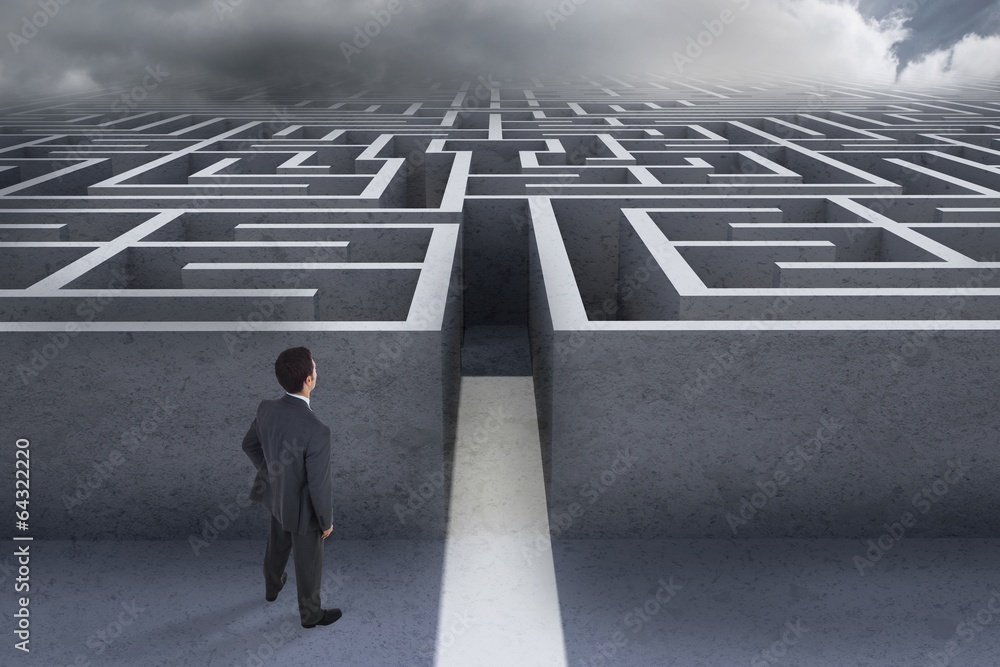 Composite image of businessman standing with hand on hip Composite image of businessman standing with hand on hip