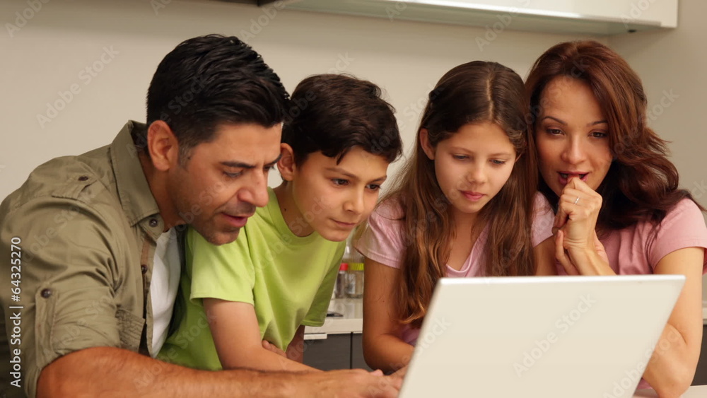 Parents using laptop with their cute children Parents using laptop with their cute children