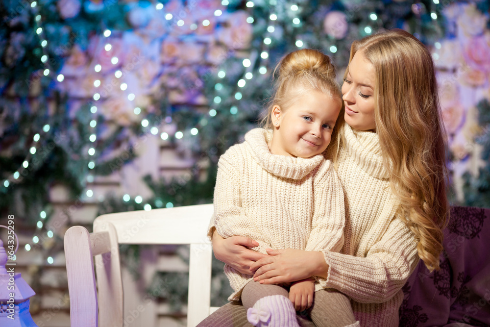 Winter mother and daughter. Smiling woman and child. Cute girl w Winter mother and daughter. Smiling woman and child. Cute girl w