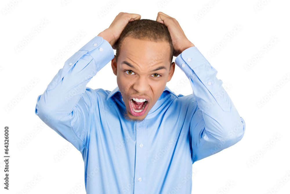 Stress. Portrait frustrated angry young man pulling his hair out Stress. Portrait frustrated angry young man pulling his hair out