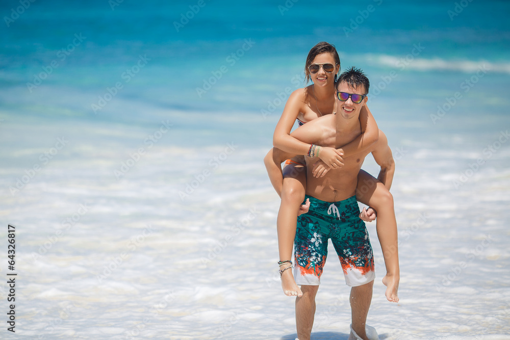 loving couple having fun on the beach of the ocean. loving couple having fun on the beach of the ocean.