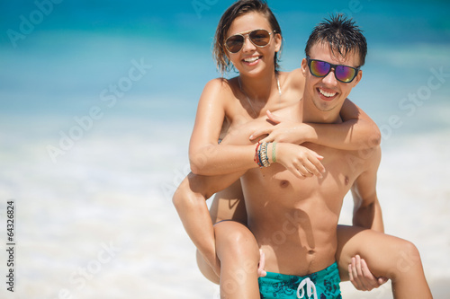 loving couple having fun on the beach of the ocean. © GTeam