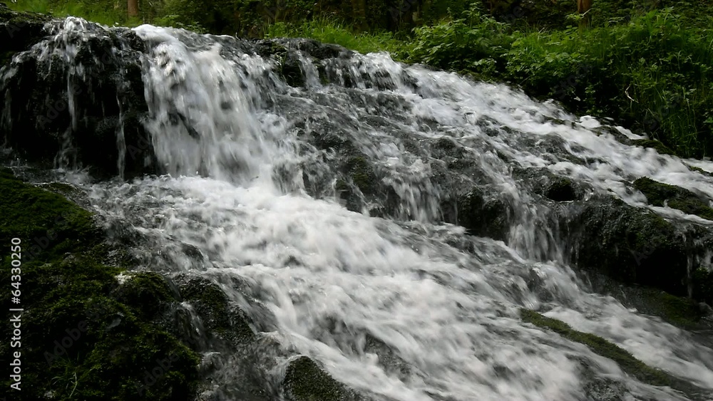 Cascade on small mountain stream, water is running trough rock Cascade on small mountain stream, water is running trough rock