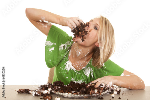 woman green shirt with cake elbow up stuff in mouth