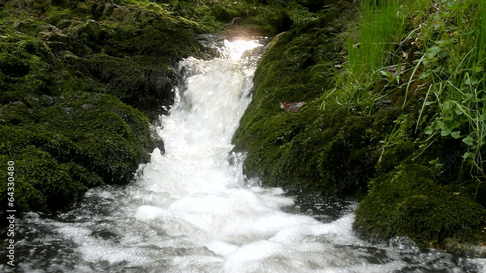 Cascade on small mountain stream, water is running trough big cr Cascade on small mountain stream, water is running trough big cr