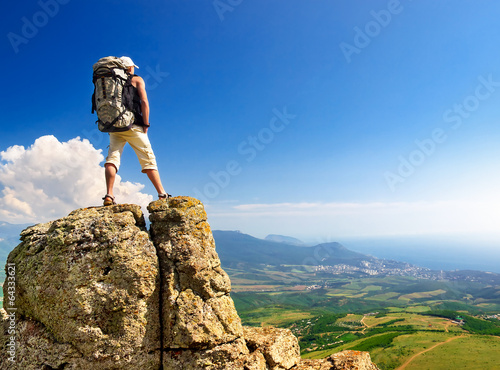 Tourist on the rock. Sport and active life concept
