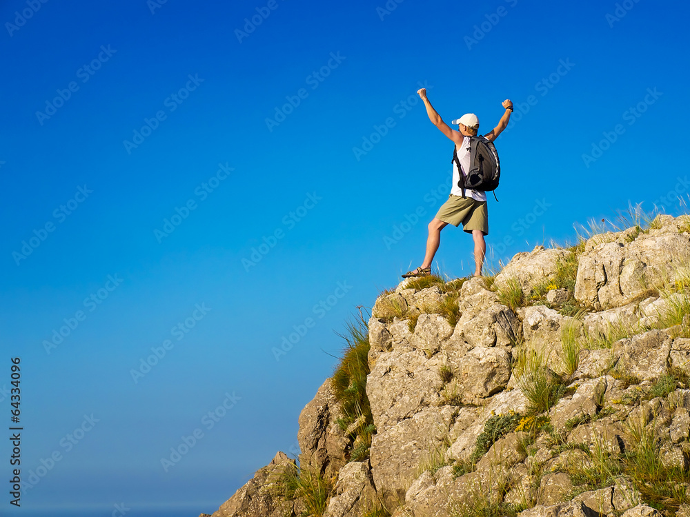 Tourist on the rock. Sport and active life concept Tourist on the rock. Sport and active life concept