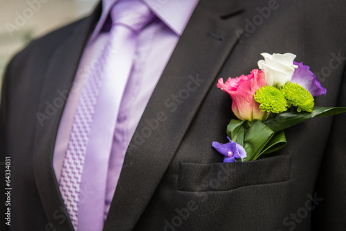 Groom with flower in the lapel of his jacket