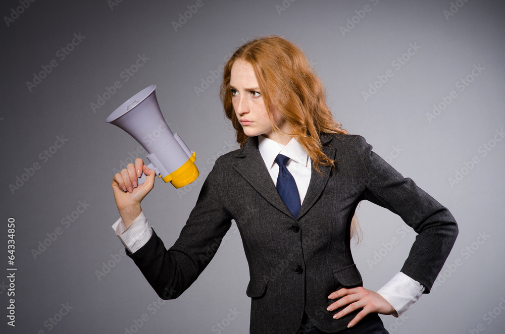 Woman with loudspeaker in studio Woman with loudspeaker in studio