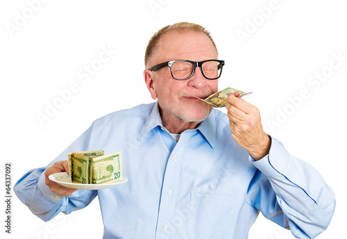 Fotografie, Tablou Hungry for money. Senior man holding plate full of cash, smells