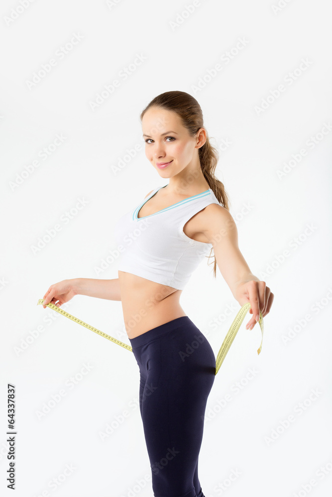 Beautiful girl measuring hip on a white background. Concept of h Beautiful girl measuring hip on a white background. Concept of h