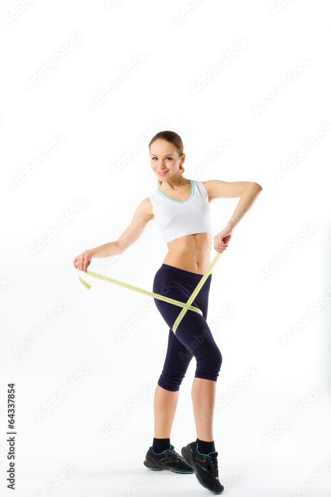 The beautiful girl measures a foot on a white background. Concep The beautiful girl measures a foot on a white background. Concep