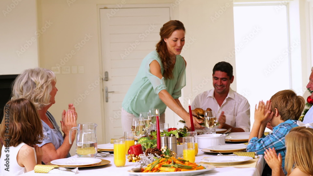 Mother bringing turkey to dinner table at christmas Mother bringing turkey to dinner table at christmas