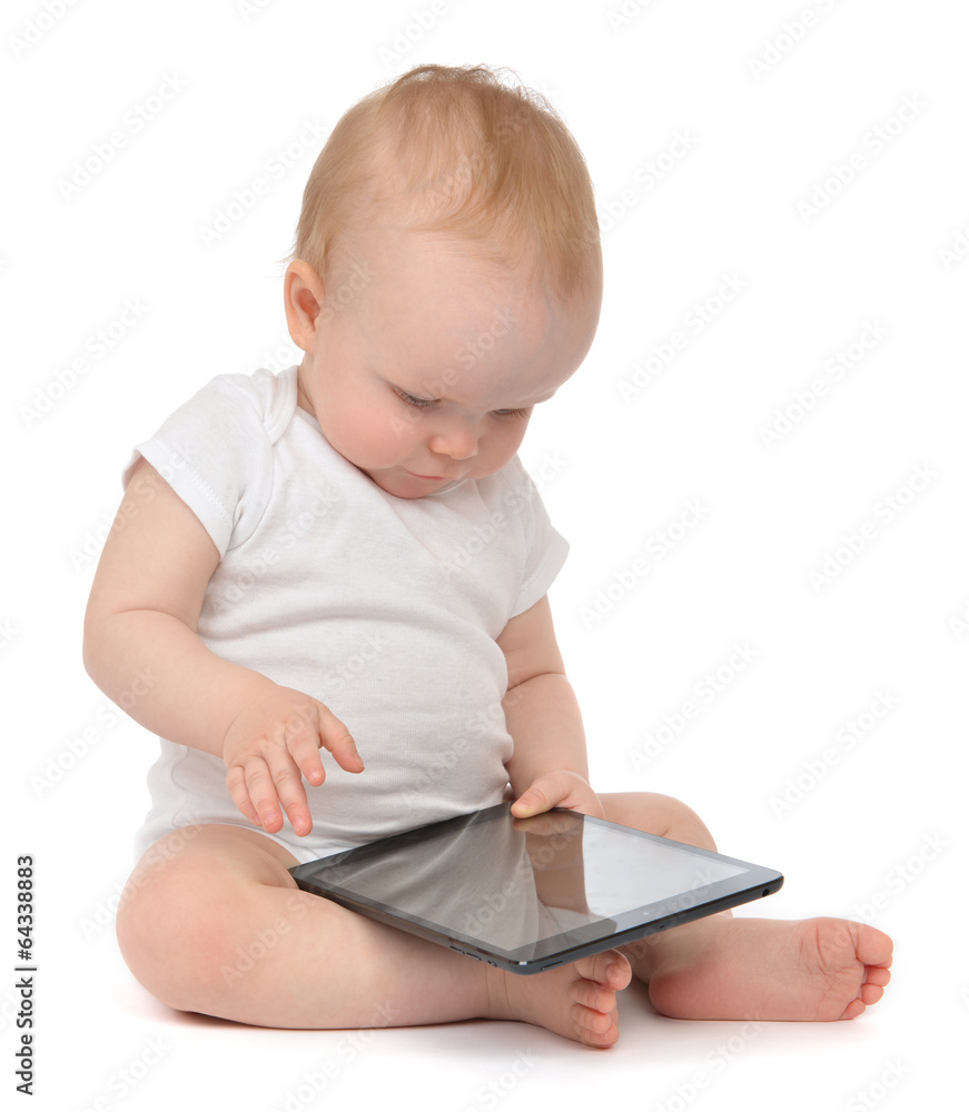 Infant child baby toddler sitting and typing digital tablet mobi Infant child baby toddler sitting and typing digital tablet mobi