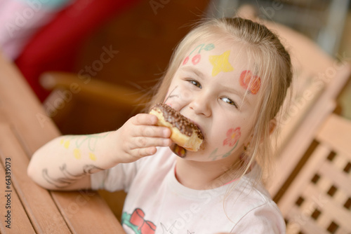 Little girl eating donut
