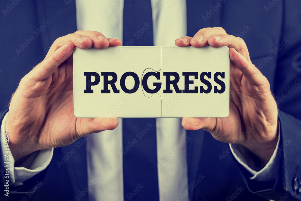 Two joined puzzle pieces with the word Progress Stock Photo | Adobe Stock