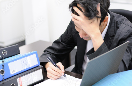 Thoughtful or stressful businessman at work