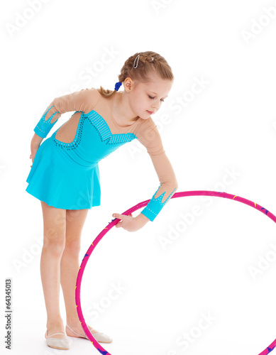 Beautiful little gymnast with the hoop