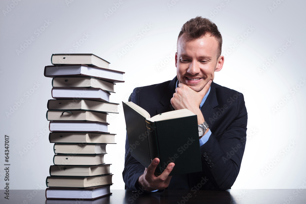pensive business man smiles while reading pensive business man smiles while reading