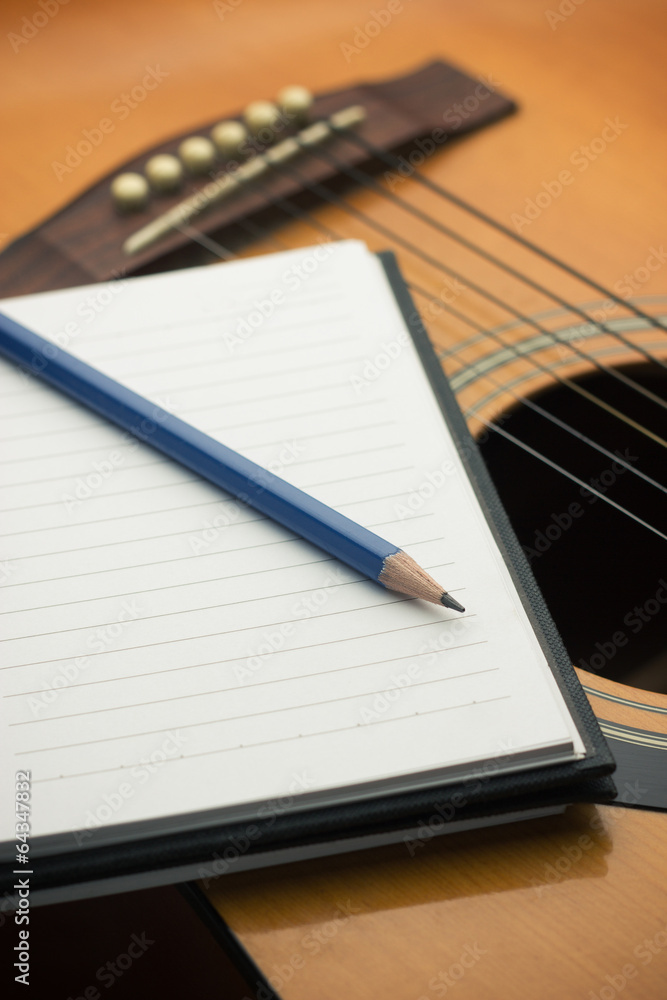Notebook and pencil on guitar Notebook and pencil on guitar