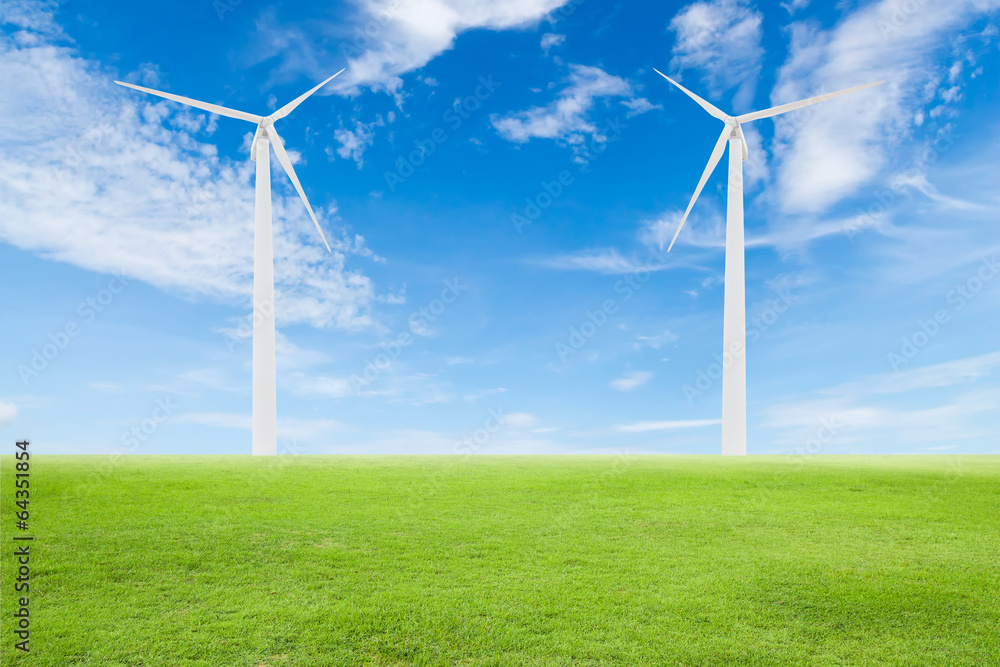 Fototapeta premium wind turbine on green grass with blue sky