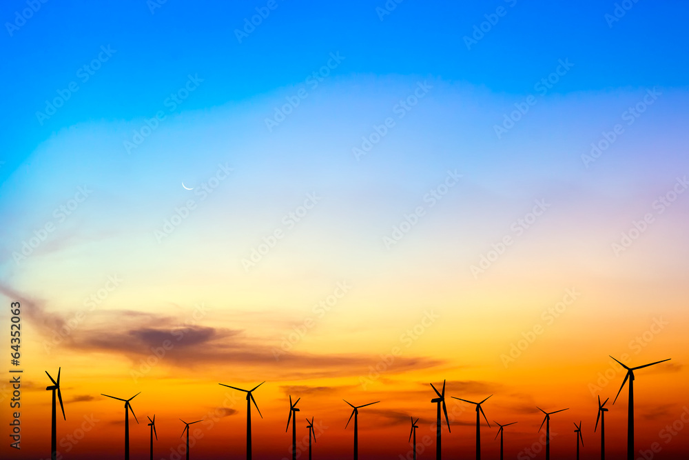 Obraz premium wind turbine silhouette on colorful sunset